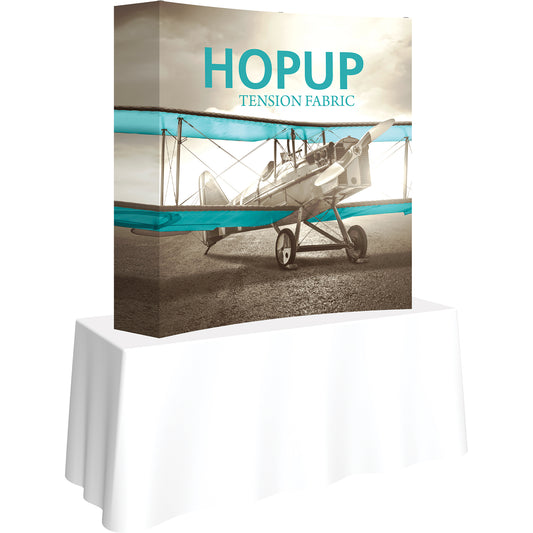 A Hopup™ 2×2 curved pop-up tabletop display set up as a 5′ × 5′ smooth tension fabric graphic, facing right. Perfect for advertising at meetings and retail.